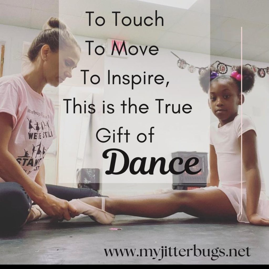 dance teacher fixing a small dancers feet
