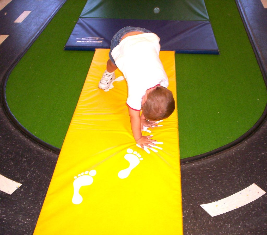 a boy working on cartwheels in Jitterbugs Tumbling class