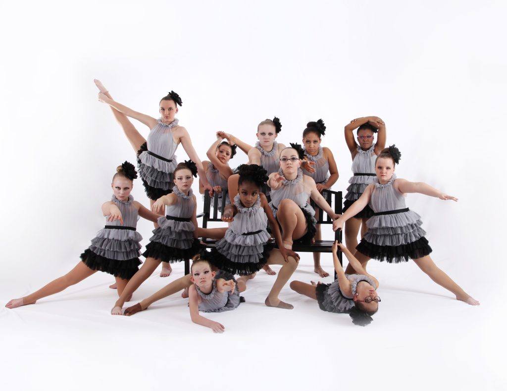 Lyrical Dancer posing around a black bench