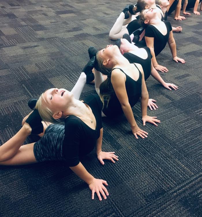 several girls doing mermaids in tumbling classes