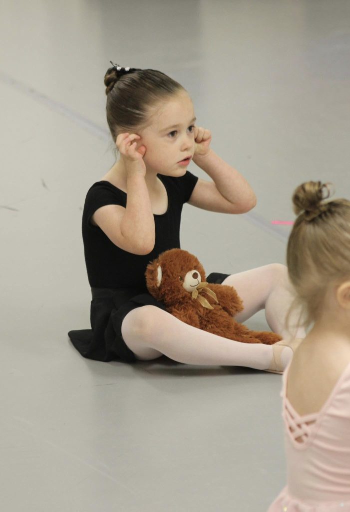 4 year old ballet dancer doing a butterfly stretch